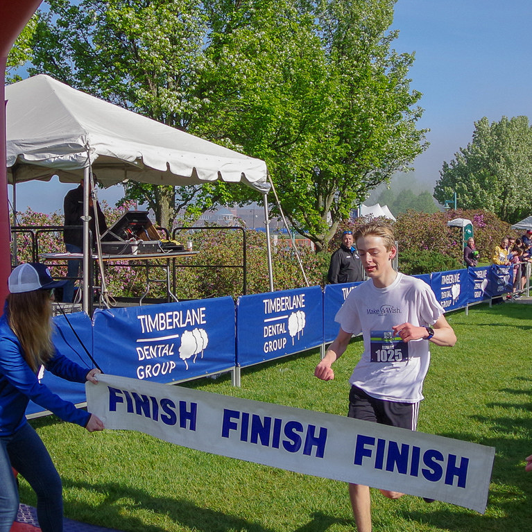 Youth crossing the finish line during race