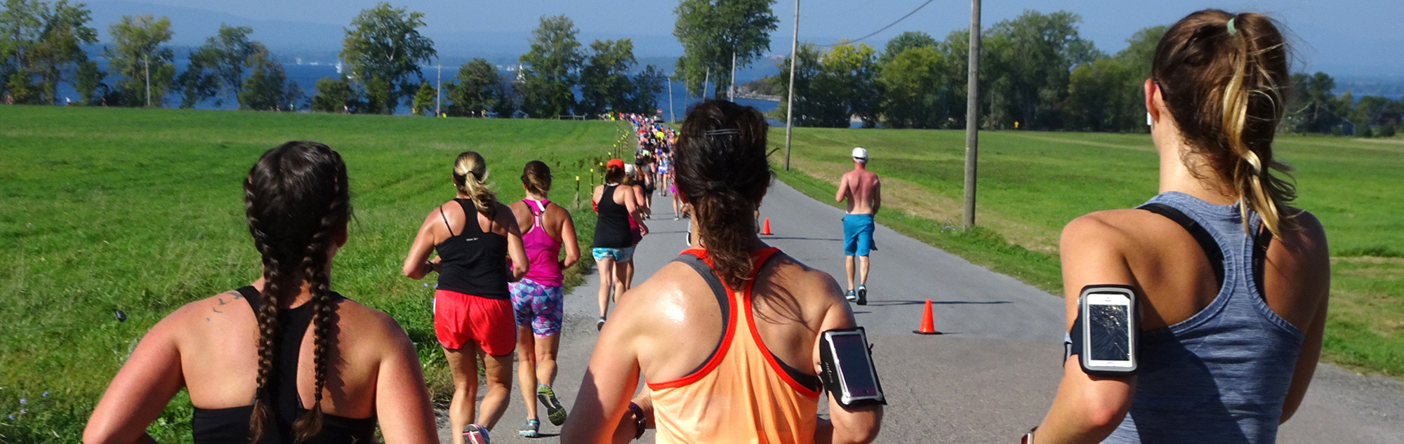 Women running with Lake Champlain in the distance